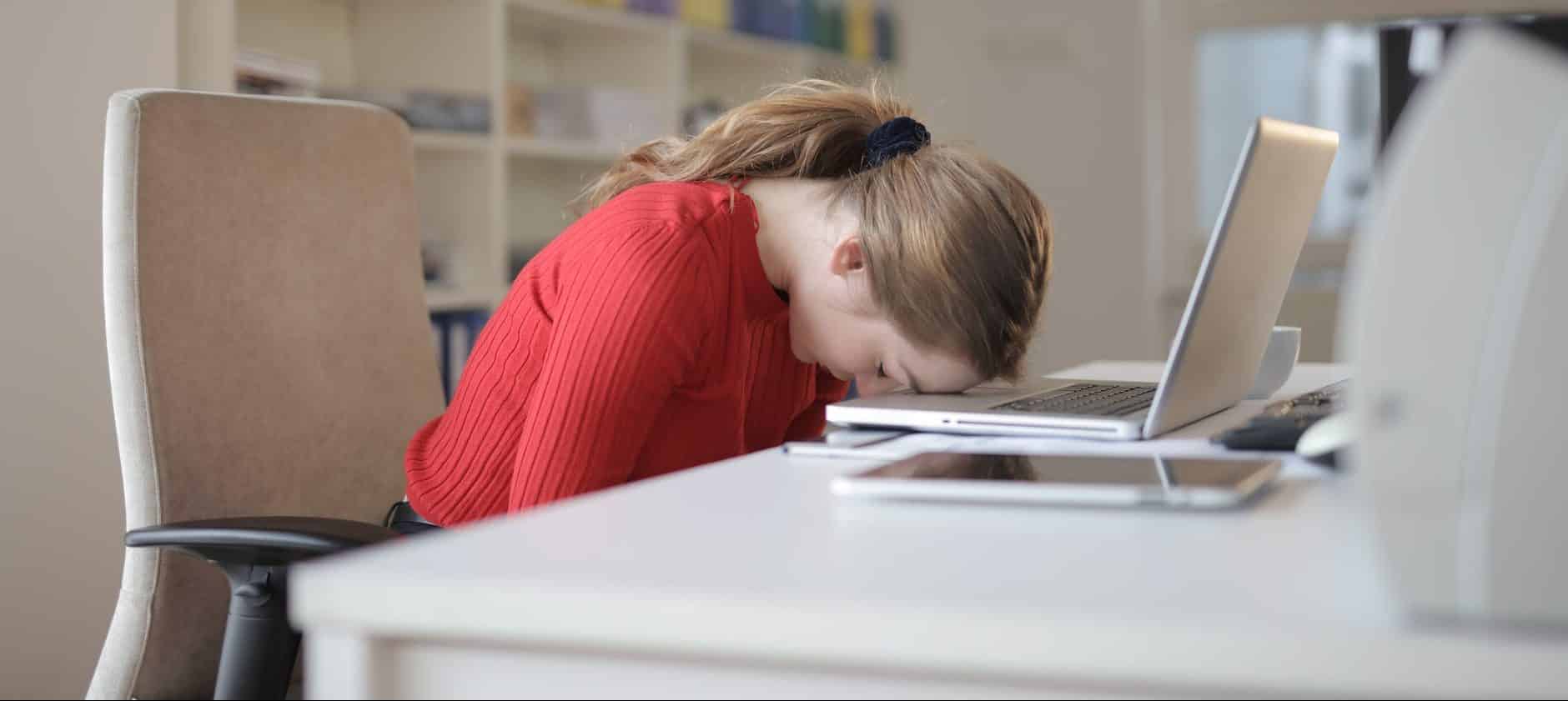 woman sitting on chair while leaning on laptop
